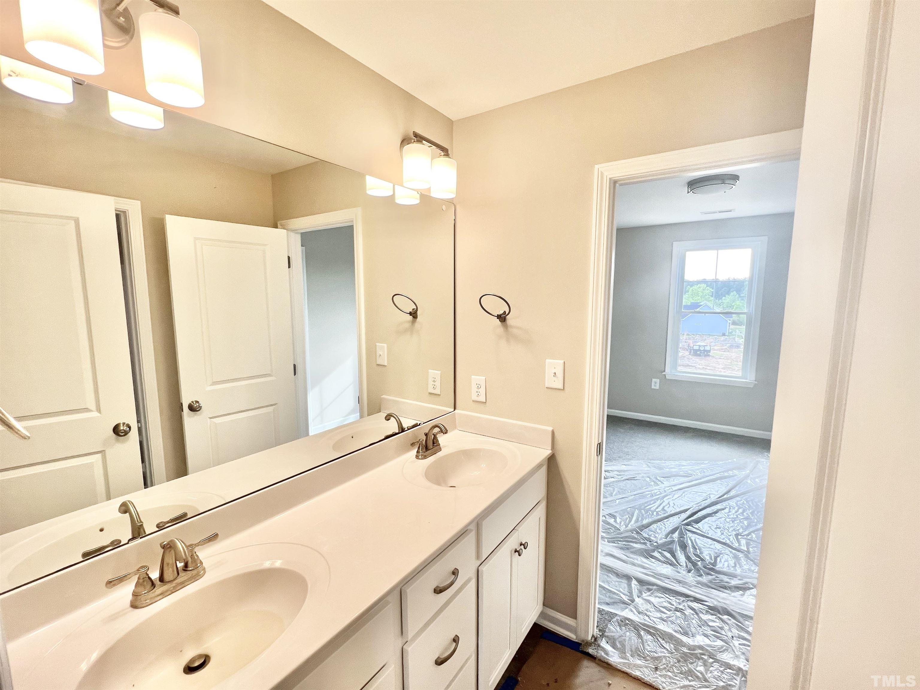4525 Debnam Road Zebulon, NC 27597 - Photo 7 of 10 a bathroom with a sink double vanity and a mirror