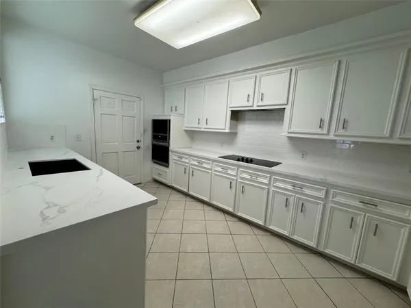 a kitchen with cabinets and appliances