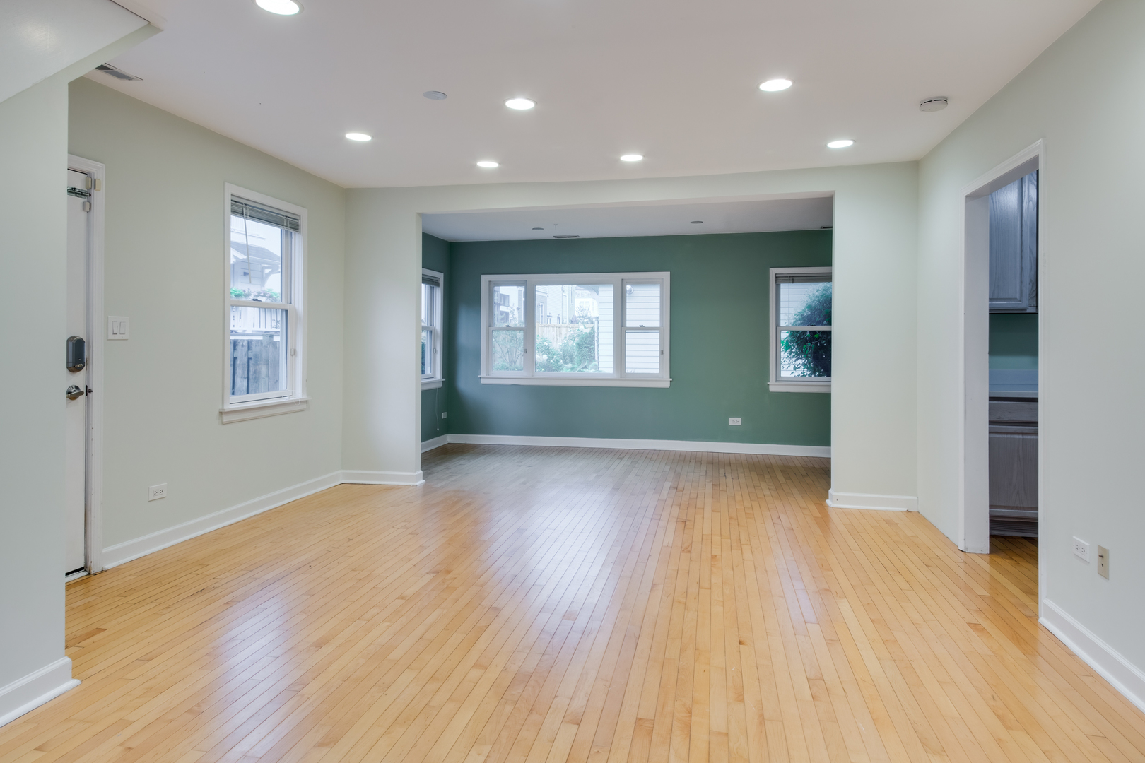 2108 Harrison Street Evanston, IL 60201 - Photo 3 of 16 an empty room with wooden floor and windows
