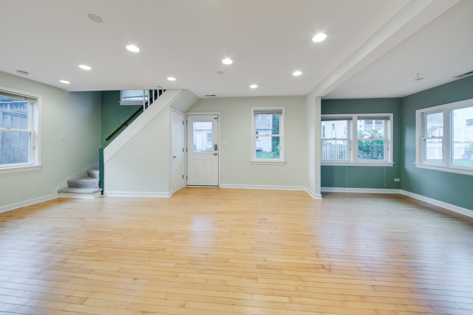 2108 Harrison Street Evanston, IL 60201 - Photo 4 of 16 an empty room with wooden floor and windows