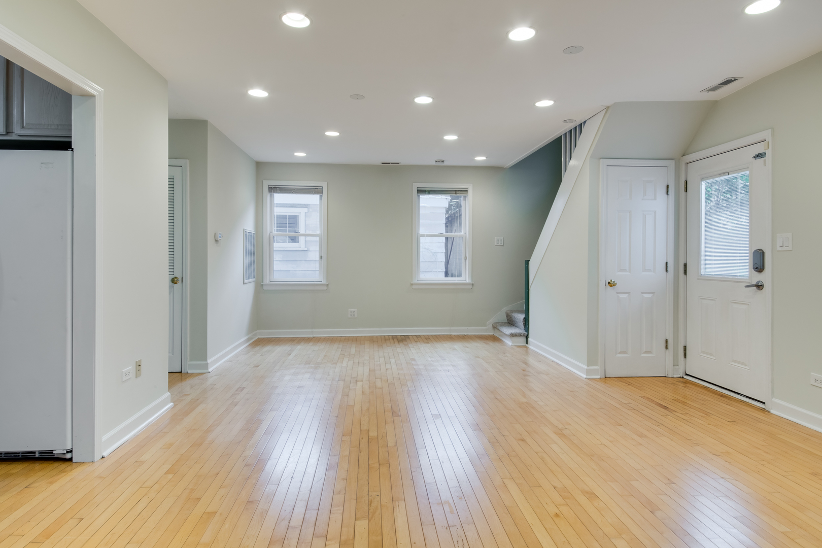 2108 Harrison Street Evanston, IL 60201 - Photo 5 of 16 an empty room with wooden floor and windows