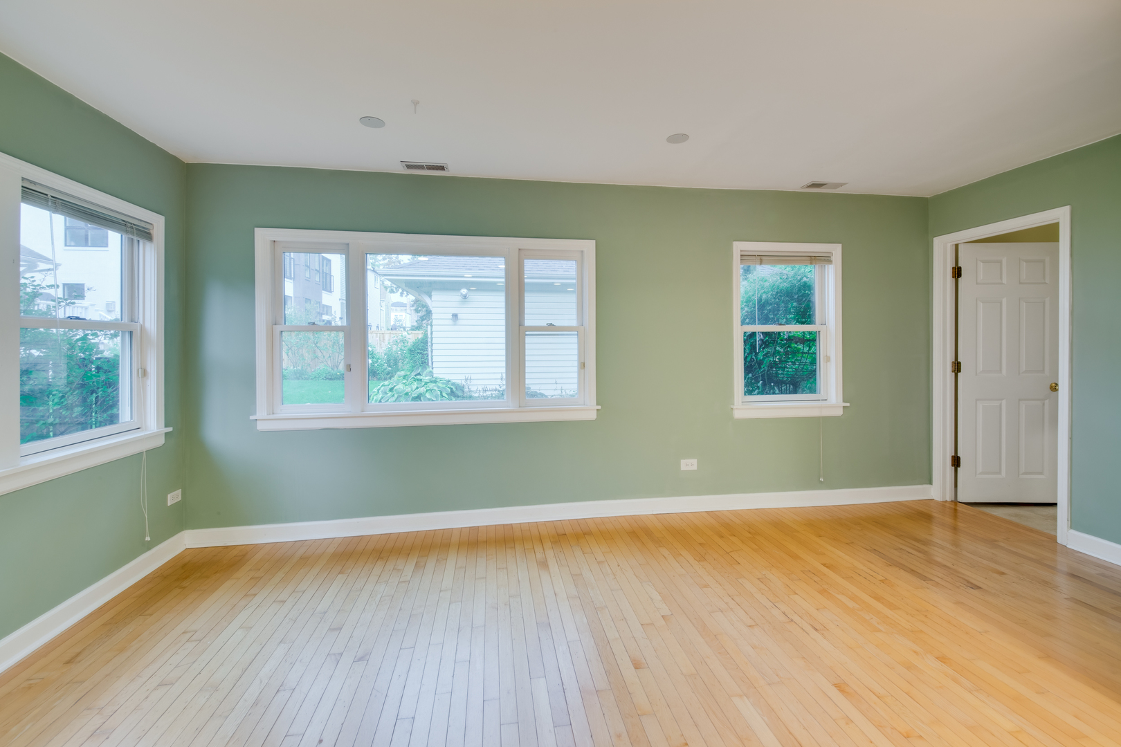 2108 Harrison Street Evanston, IL 60201 - Photo 6 of 16 a view of empty room with wooden floor and fan