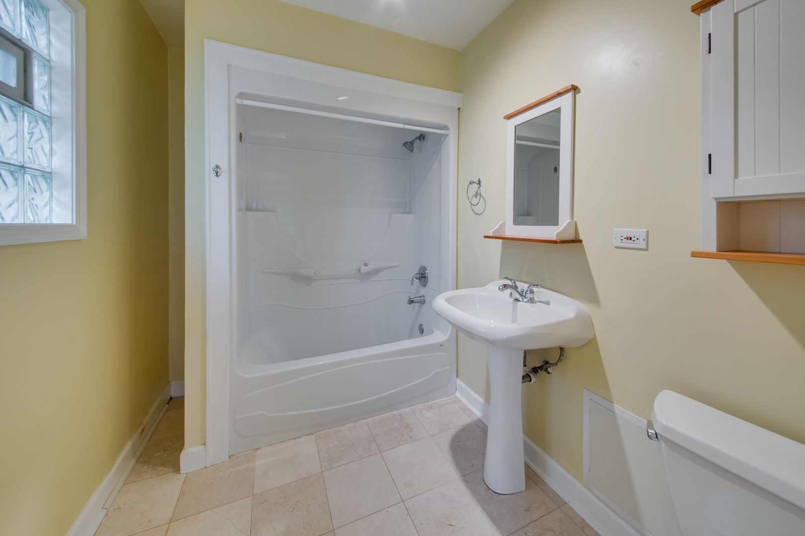 2108 Harrison Street Evanston, IL 60201 - Photo 7 of 16 a bathroom with a sink a toilet and shower