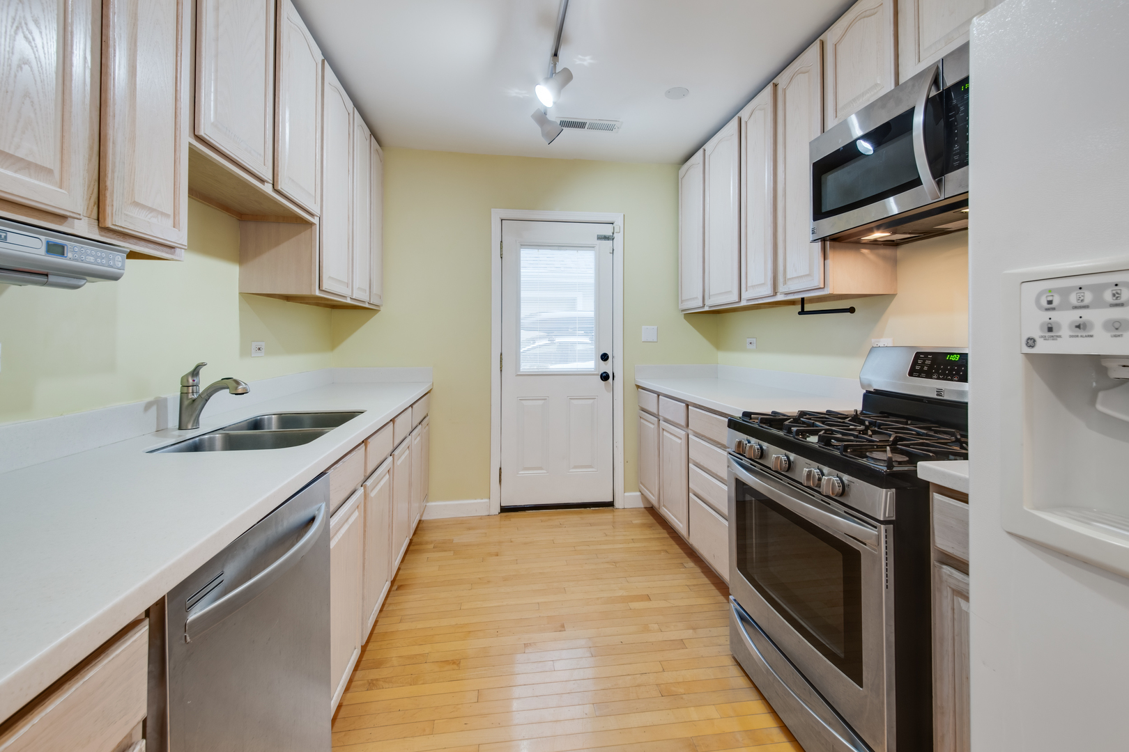2108 Harrison Street Evanston, IL 60201 - Photo 8 of 16 a kitchen with stainless steel appliances a sink stove and cabinets