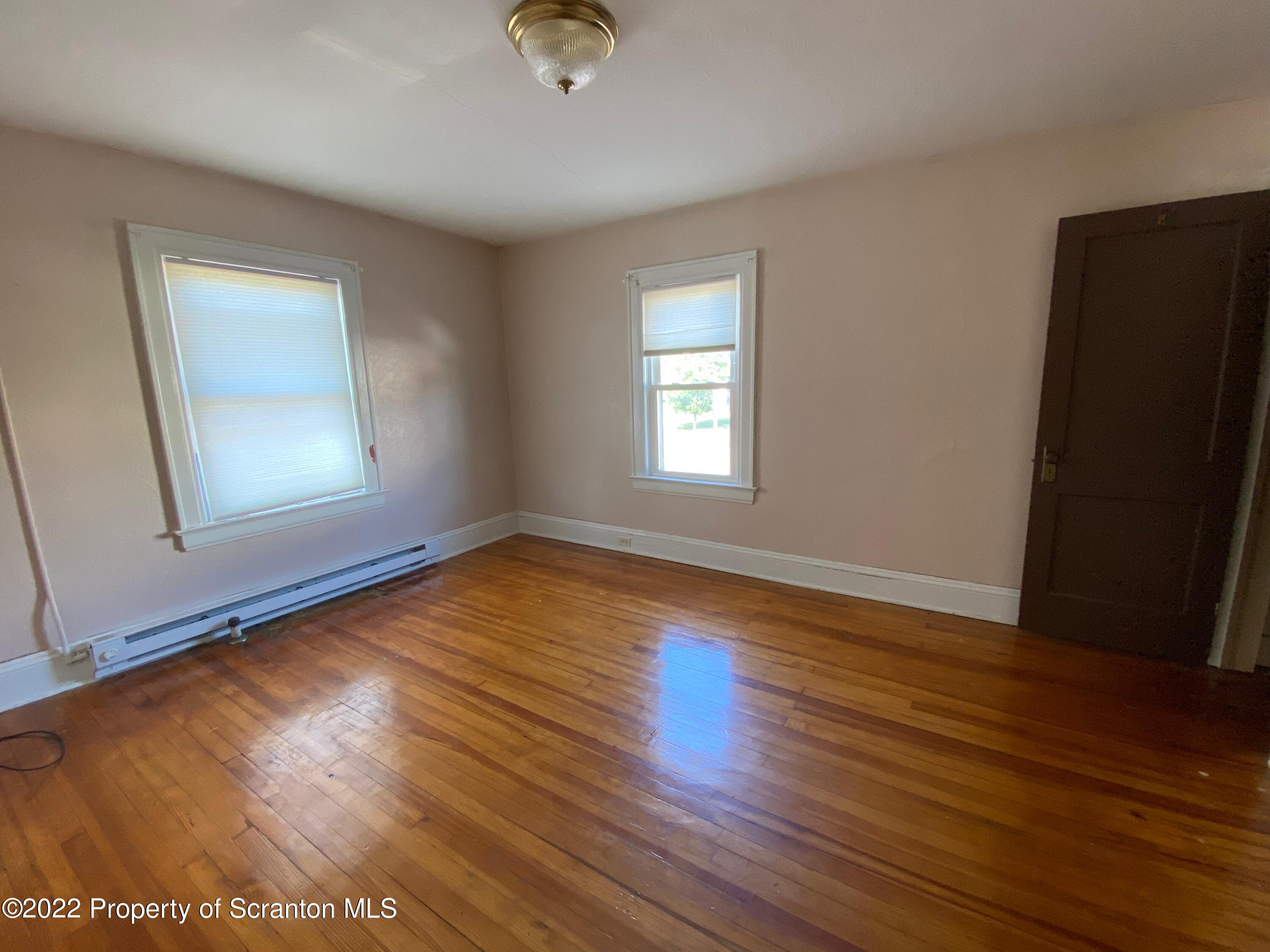 600 Main Street Moosic, PA 18507 - Photo 15 of 19 a view of empty room with wooden floor and fan