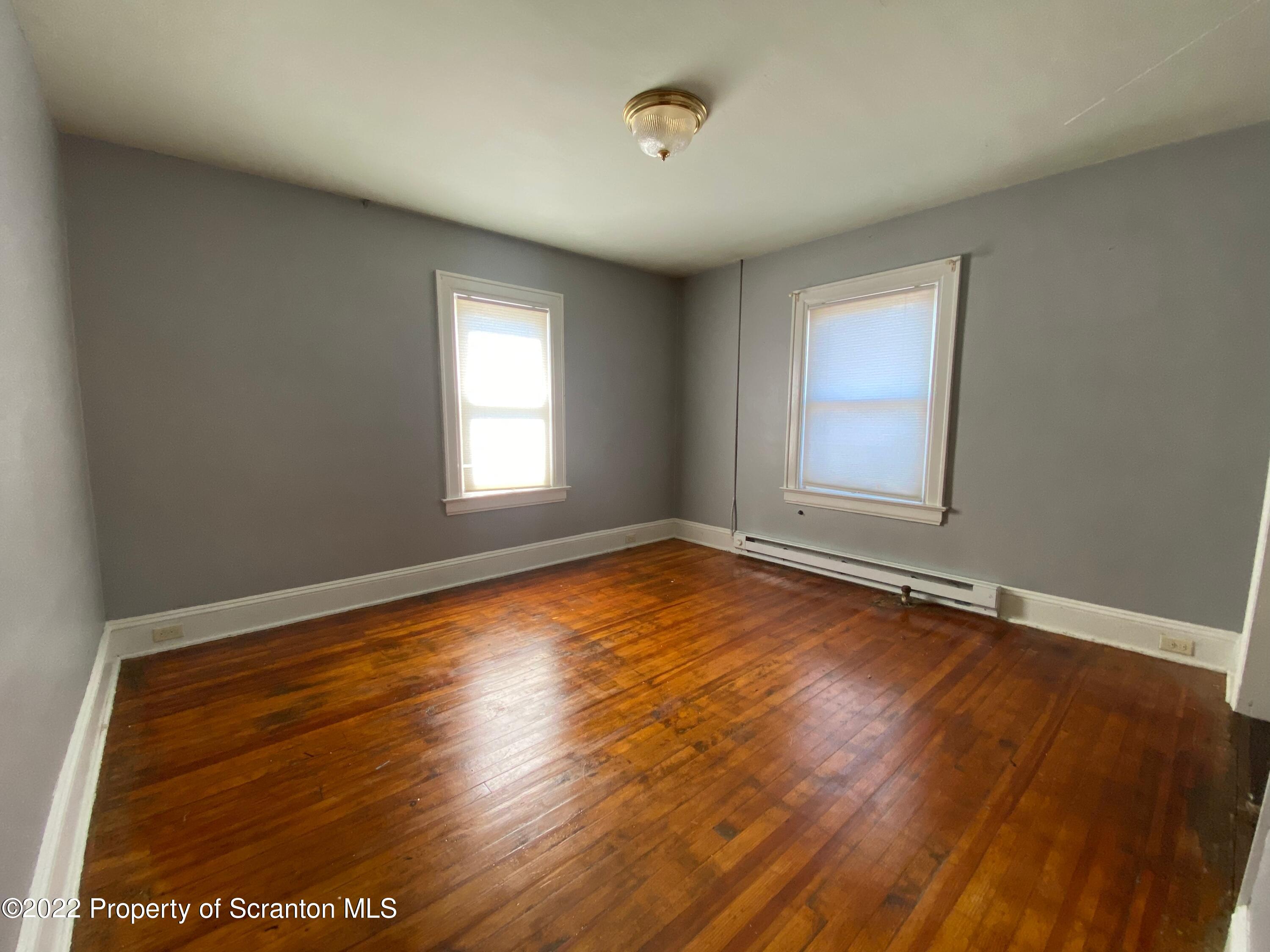 600 Main Street Moosic, PA 18507 - Photo 16 of 19 an empty room with wooden floor and windows