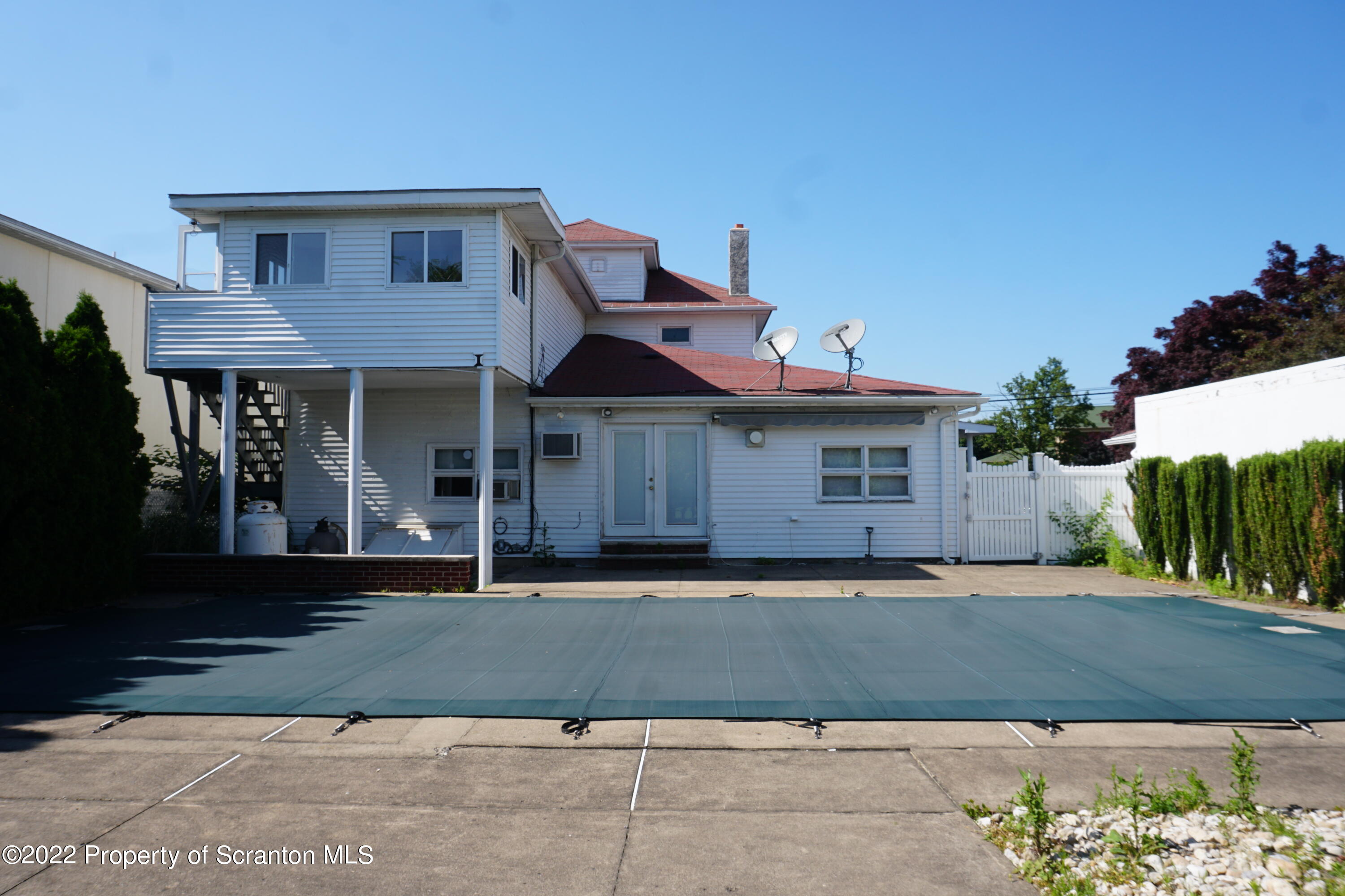 600 Main Street Moosic, PA 18507 - Photo 18 of 19 a front view of a house with a garden and a garage