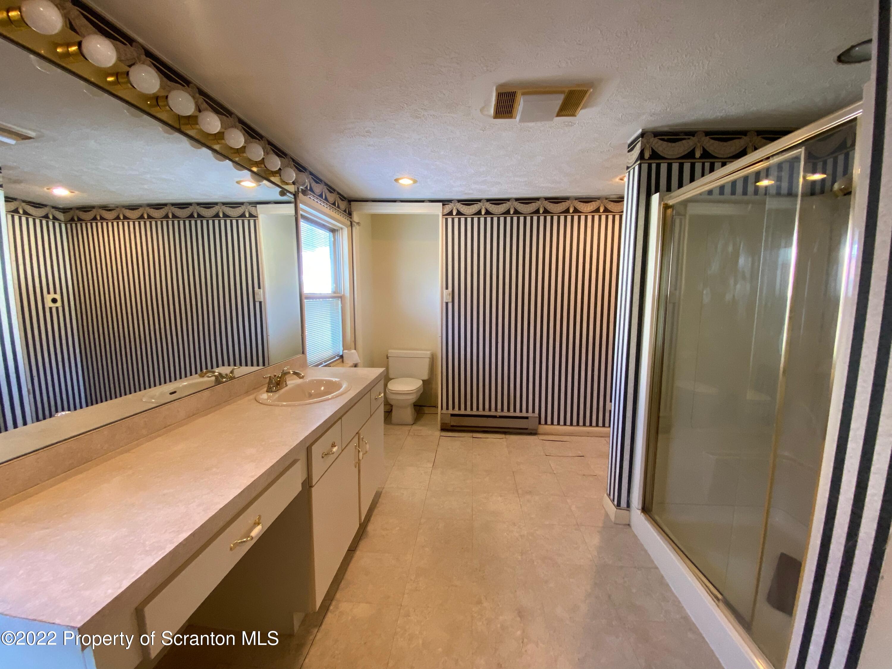 600 Main Street Moosic, PA 18507 - Photo 5 of 19 a bathroom with a sink and a mirror