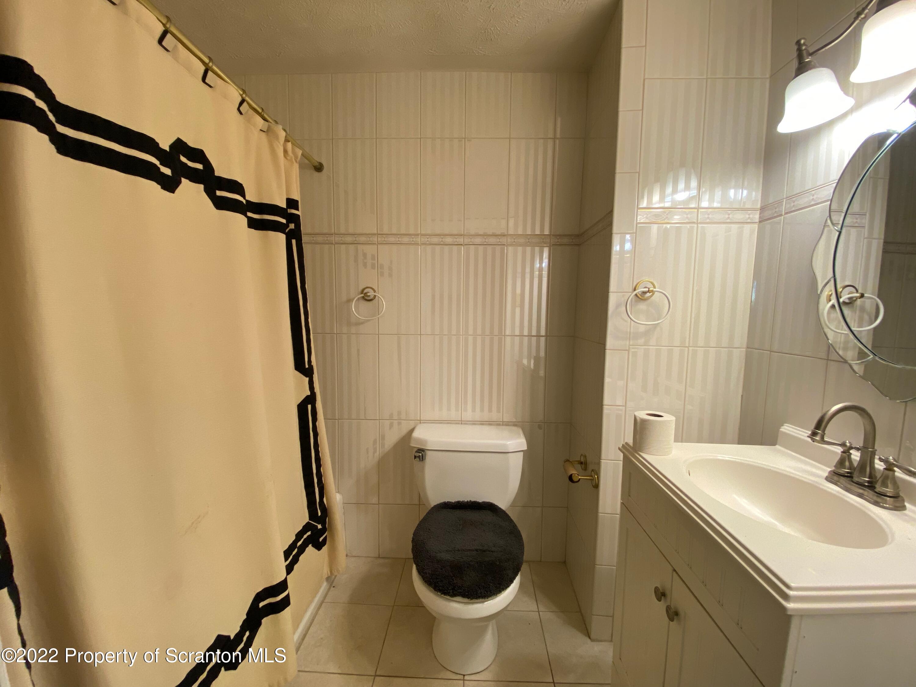 600 Main Street Moosic, PA 18507 - Photo 6 of 19 a bathroom with a sink a toilet and shower