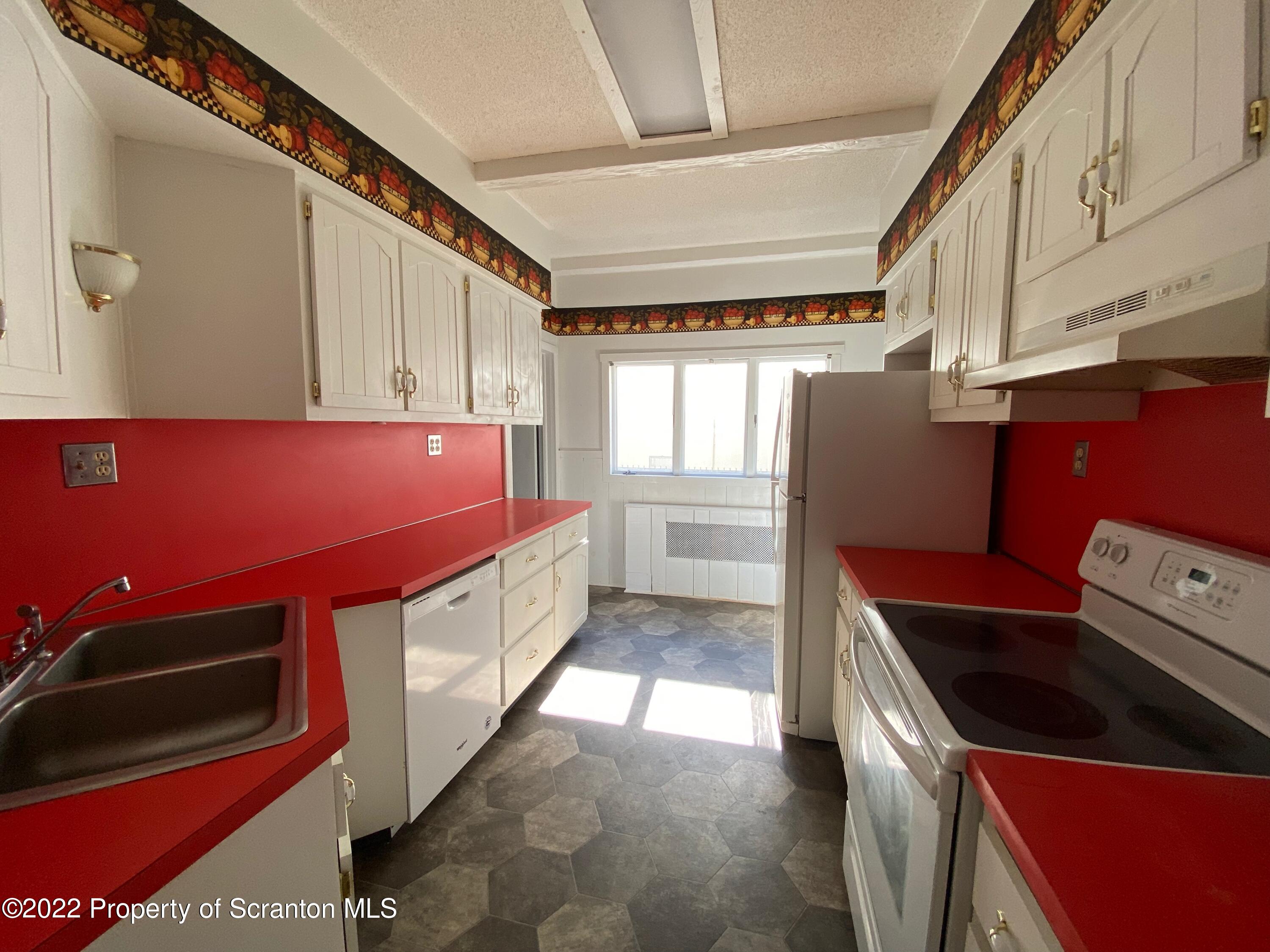 600 Main Street Moosic, PA 18507 - Photo 9 of 19 a kitchen with stainless steel appliances granite countertop a stove a microwave and a refrigerator
