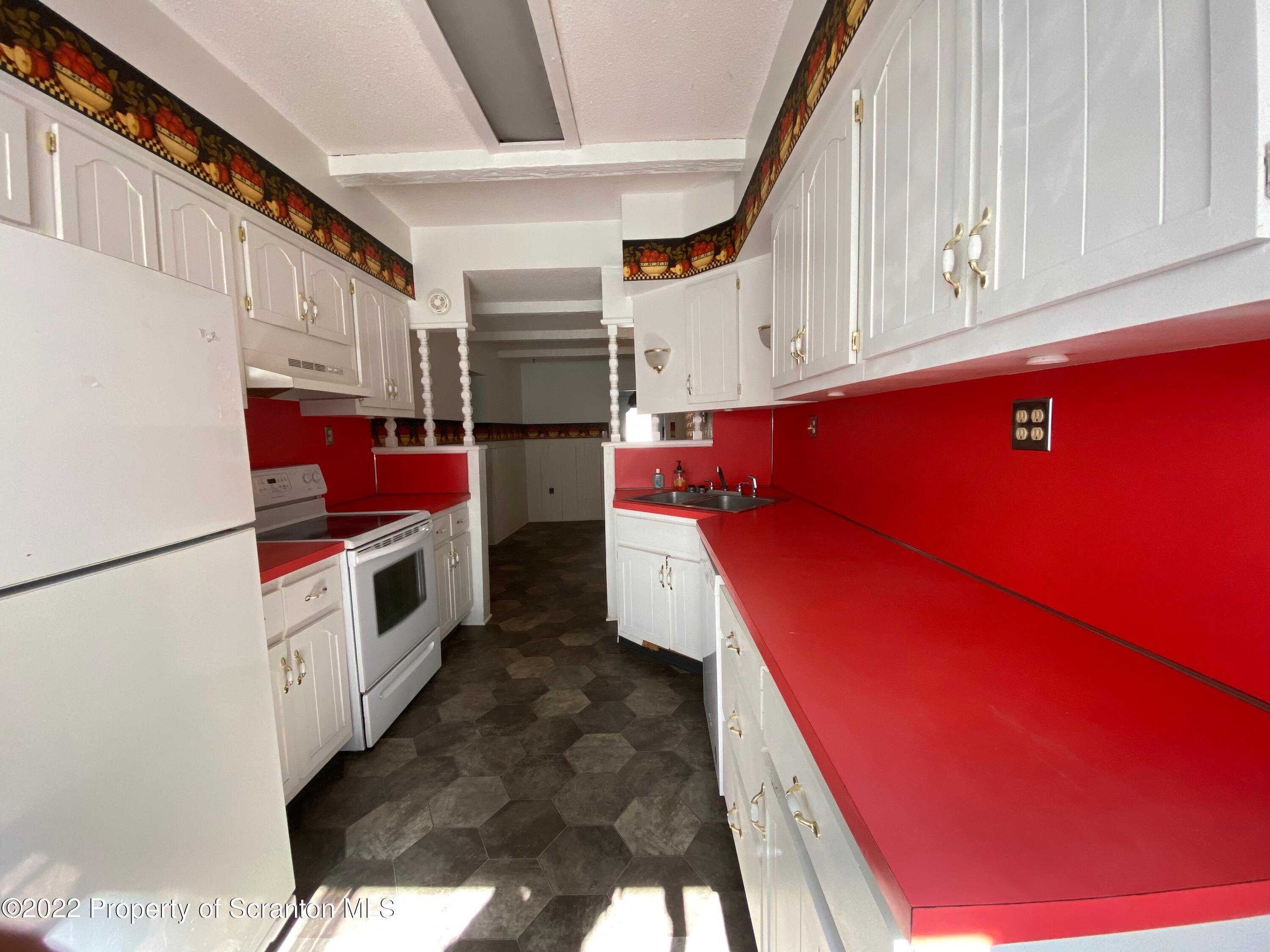 600 Main Street Moosic, PA 18507 - Photo 10 of 19 a kitchen with stainless steel appliances kitchen island wooden cabinets and a refrigerator