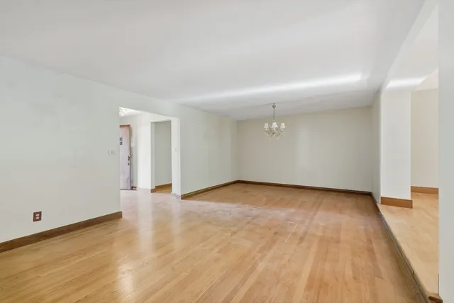 a view of an empty room and wooden floor