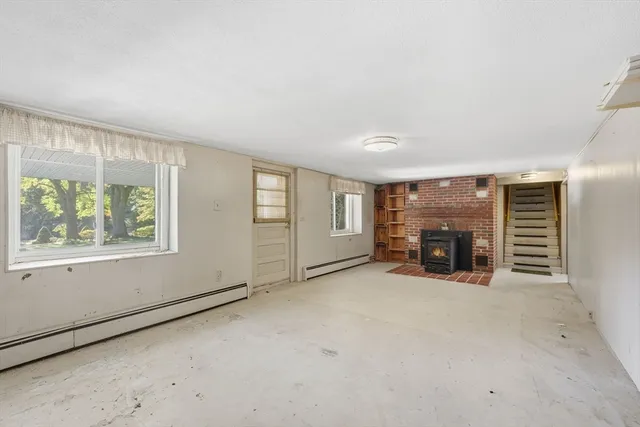 an empty room with furniture and a fireplace