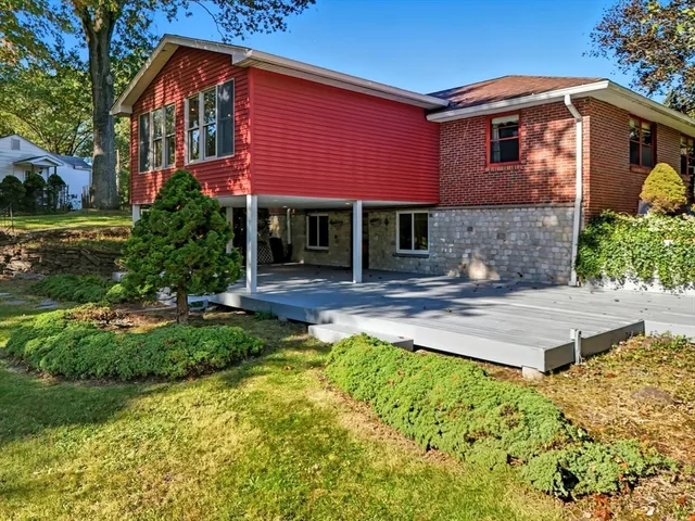 a front view of a house with yard and green space