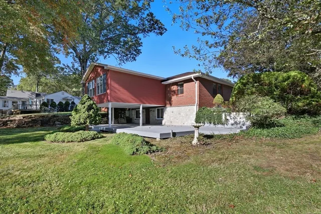 a white house that has a tree in front of it