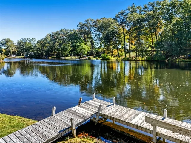 a view of a lake with couches chairs