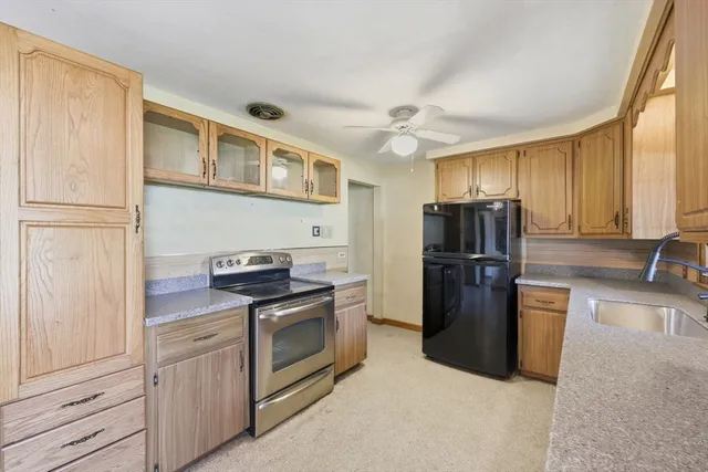 a kitchen with stainless steel appliances granite countertop a refrigerator stove and sink