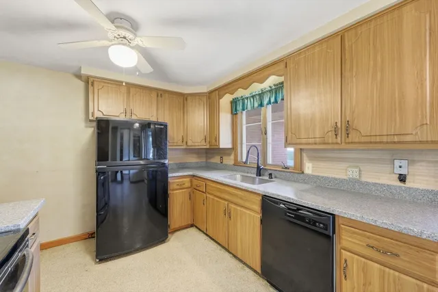 a kitchen with stainless steel appliances granite countertop a sink a stove and refrigerator