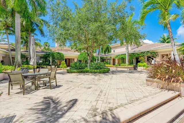 a view of a livingroom with furniture and floor to ceiling window