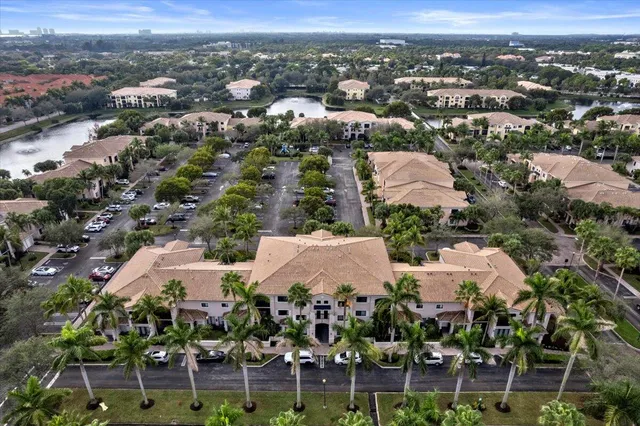 an aerial view of residential houses with outdoor space and trees