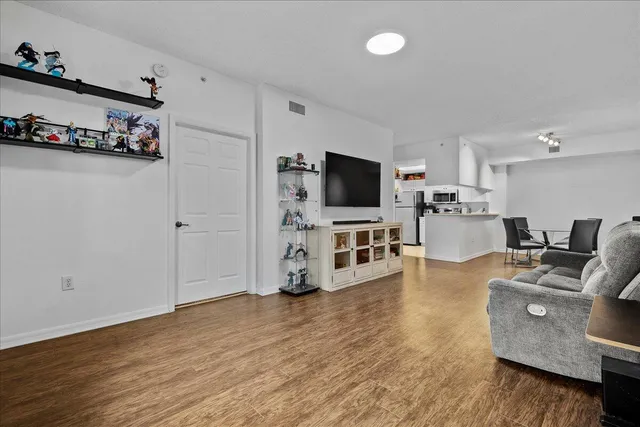 a view of a kitchen with furniture and wooden floor