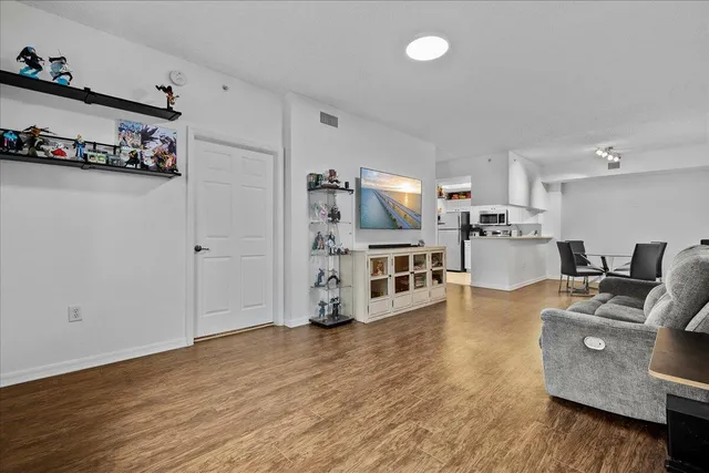 a living room with furniture and a wooden floor