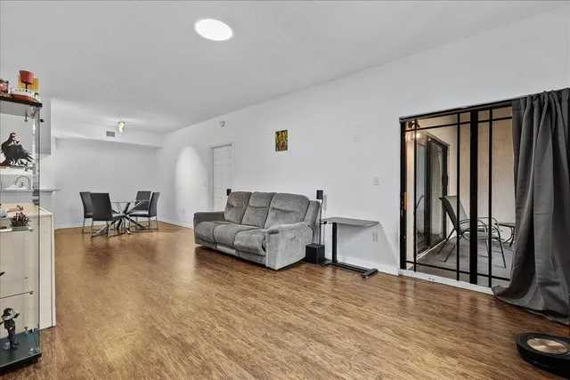 a view of a dining room with furniture and wooden floor
