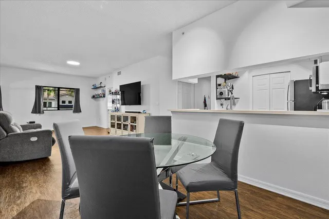 a view of a dining room with furniture window and wooden floor