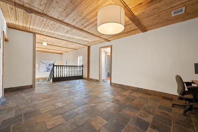 a spacious bedroom with a bed a couch and a window