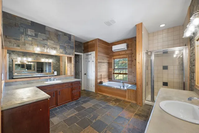 a large bathroom with a large tub and sink