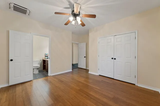 a view of empty room with wooden floor
