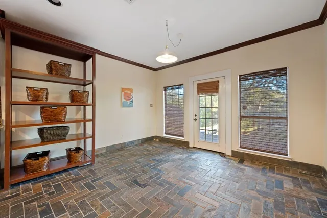 a view of kitchen with stainless steel appliances kitchen island granite countertop a refrigerator and a stove