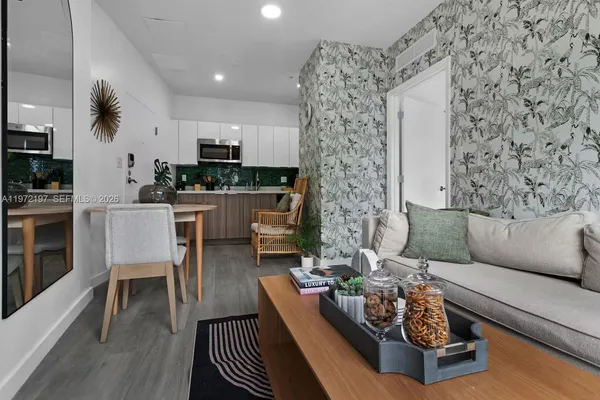 a living room with furniture and wooden floor