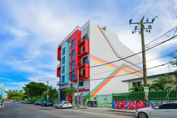 a view of hallway with wooden floor