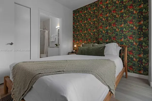 a bedroom with a bed and a night stand