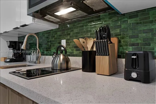 a kitchen with a stove and a refrigerator