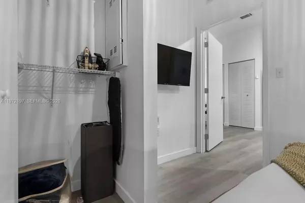 a view of a closet and mirror