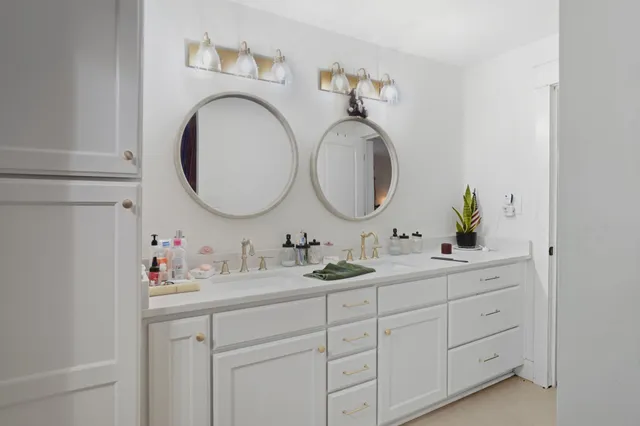 a bathroom with a double vanity sink and a mirror