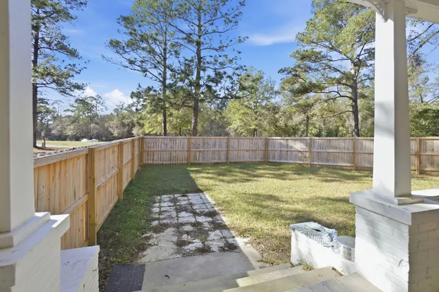 a view of swimming pool with wooden fence
