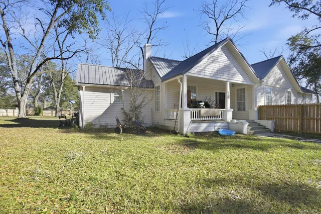 a swimming pool with outdoor seating and yard