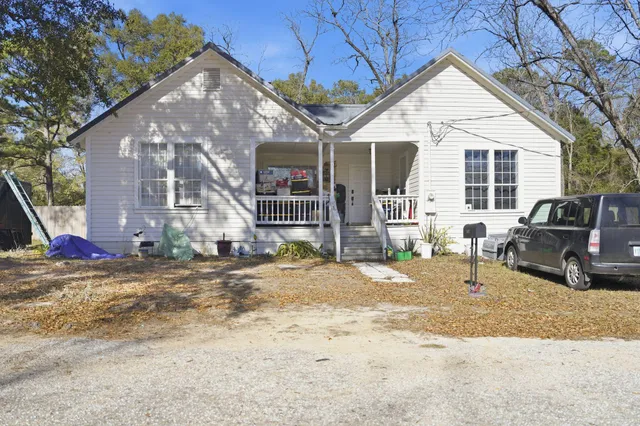 a view of a house with backyard porch and sitting area