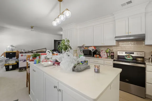 a kitchen with a sink a stove and cabinets