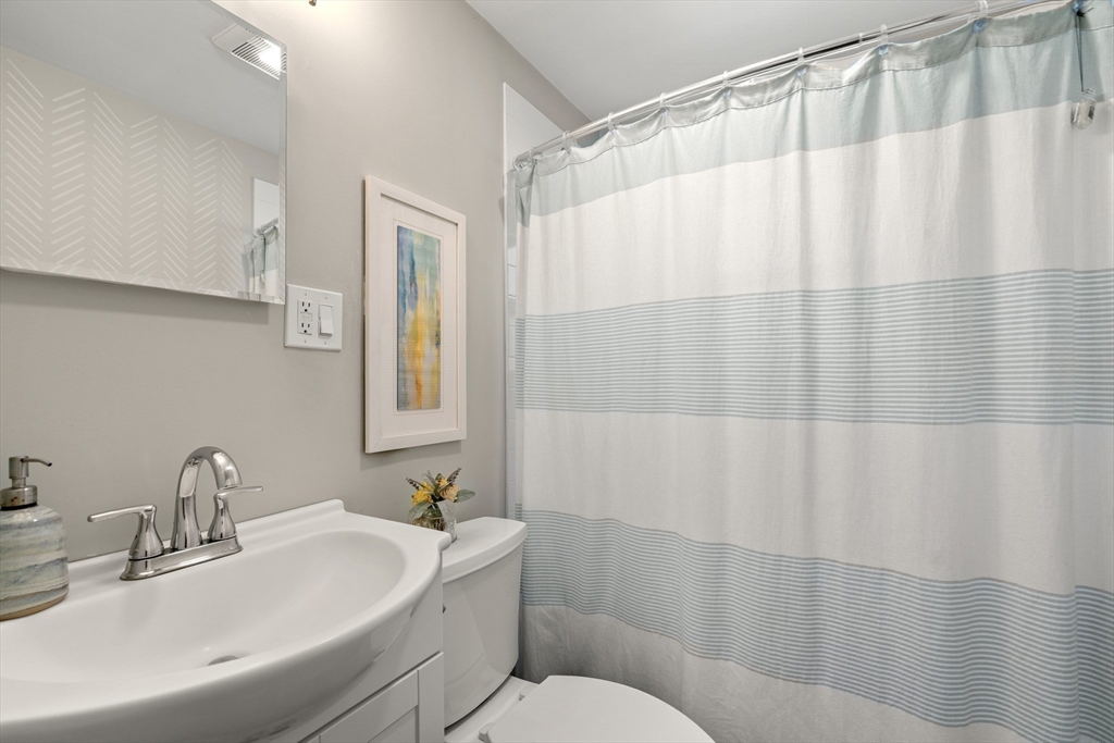 1 Dow Road Boston, MA 02132 - Photo 12 of 28 a bathroom with a sink and a mirror