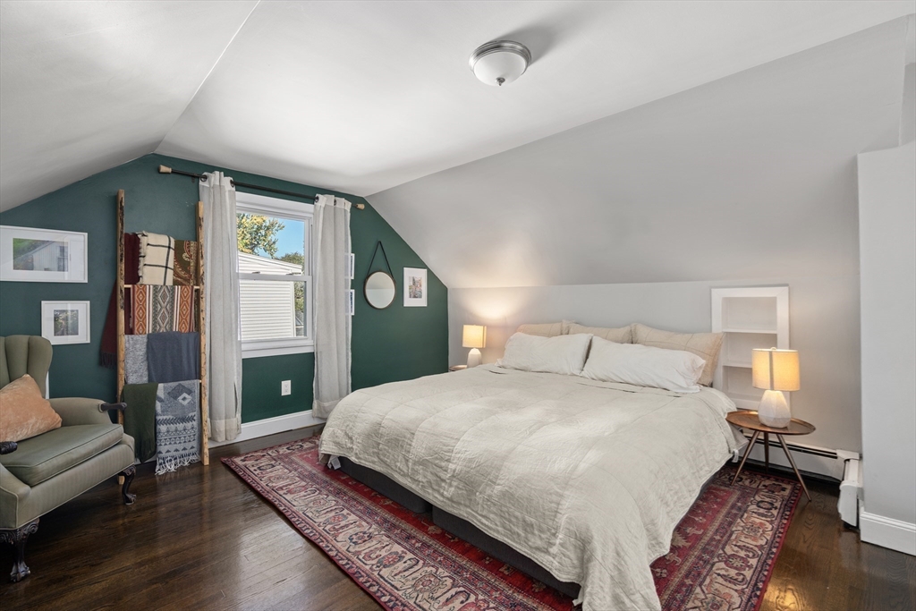 1 Dow Road Boston, MA 02132 - Photo 16 of 28 a bedroom with a large bed and a wooden floor