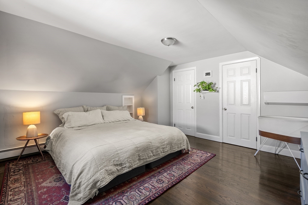 1 Dow Road Boston, MA 02132 - Photo 17 of 28 a bedroom with a bed and a potted plant
