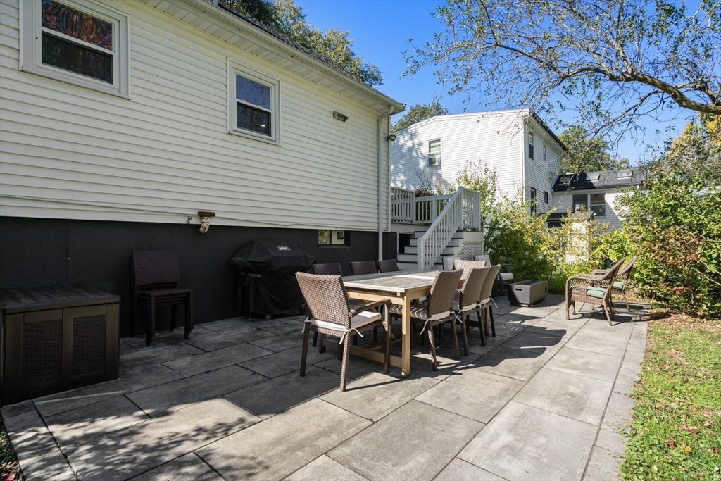 1 Dow Road Boston, MA 02132 - Photo 27 of 28 a backyard of a house with table and chairs