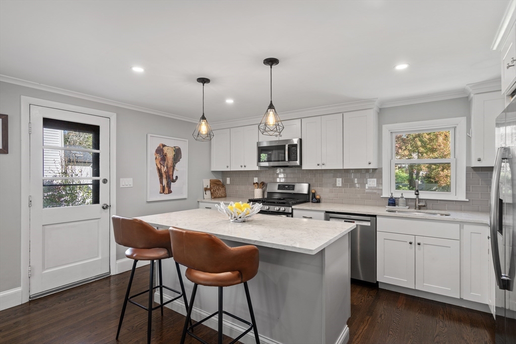1 Dow Road Boston, MA 02132 - Photo 9 of 28 a kitchen that has a lot of cabinets in it and appliances