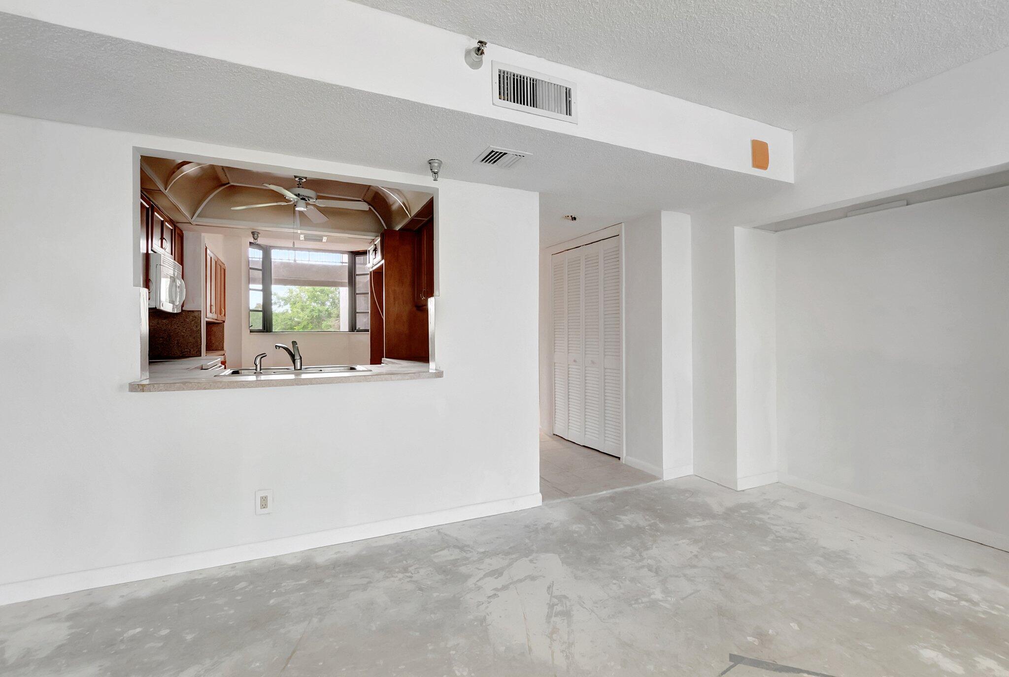6320 Boca Del Mar Drive, Unit 301 Boca Raton, FL 33433 - Photo 14 of 46 a view of a hallway to a livingroom with wooden furniture