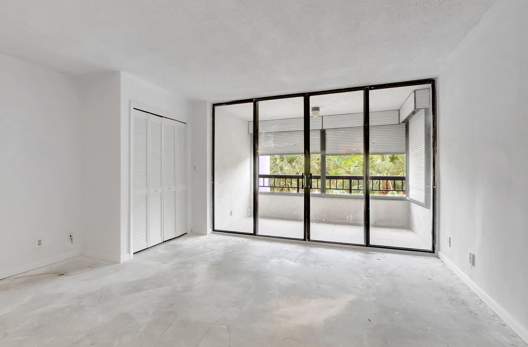 6320 Boca Del Mar Drive, Unit 301 Boca Raton, FL 33433 - Photo 22 of 46 an empty room with sliding glass door and mountain view