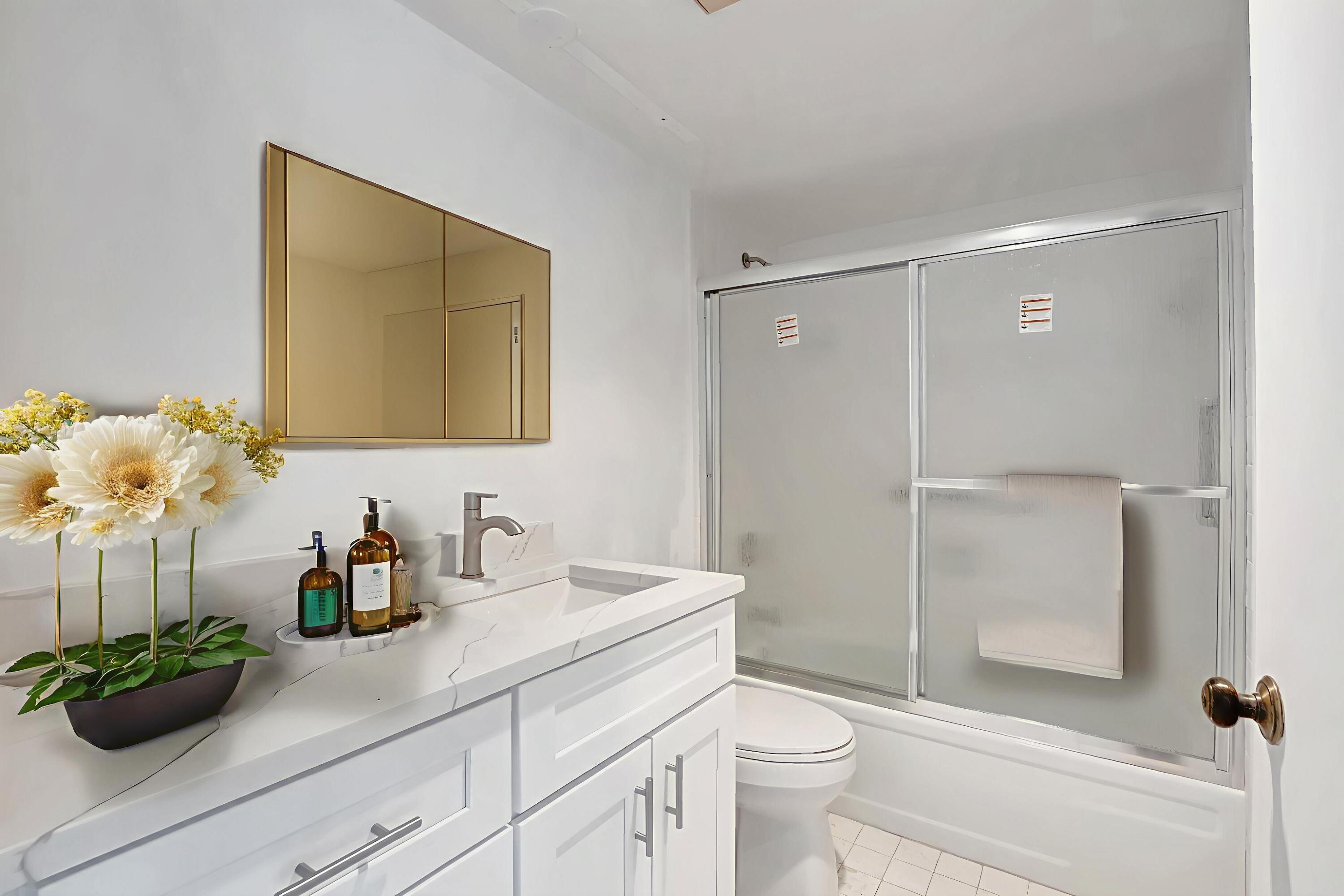 6320 Boca Del Mar Drive, Unit 301 Boca Raton, FL 33433 - Photo 8 of 46 a bathroom with a sink a toilet and shower